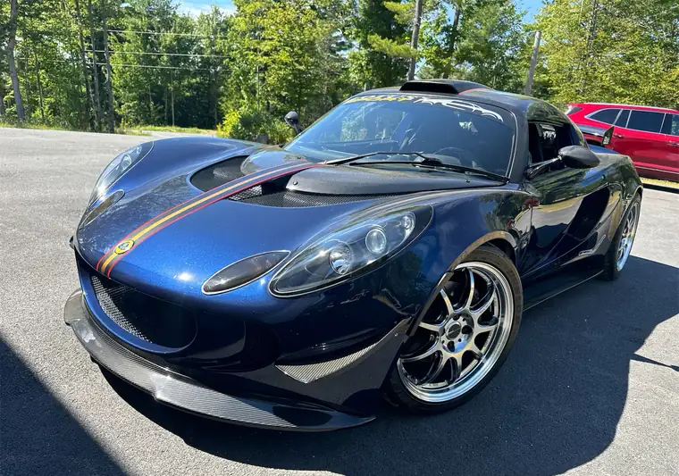The same Lotus Exige on a paved lot at delivery in Holden, Maine