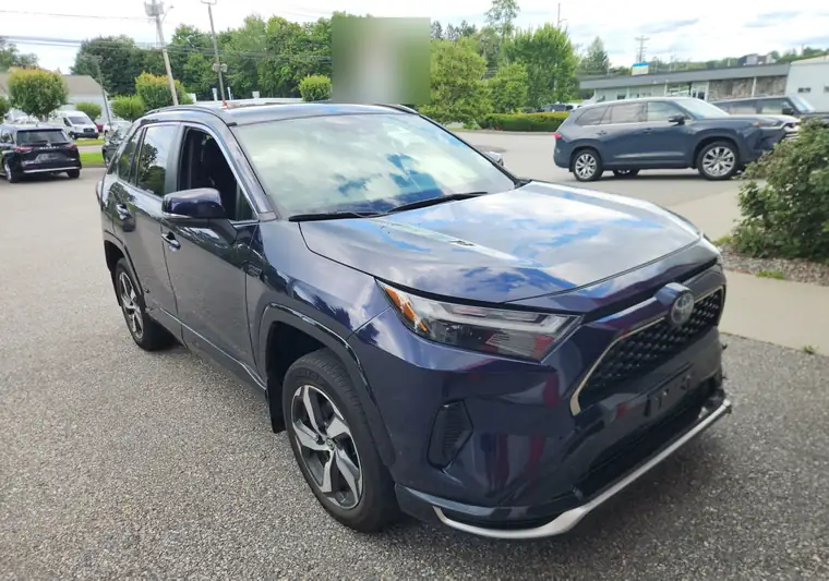 The same RAV4 Prime in a dealership parking lot at delivery in Torrington, Connecticut