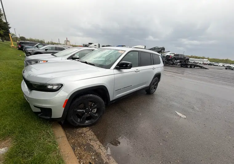 Silver 2021 Jeep Grand Cherokee L at an auction yard in Carleton, Michigan