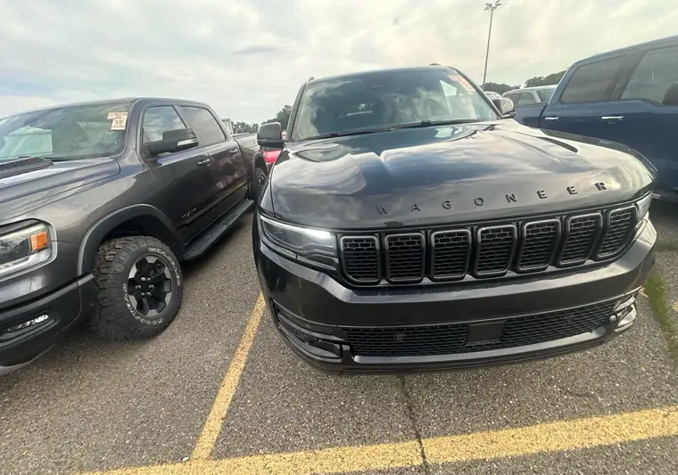 Black 2024 Jeep Wagoneer at an auction yard in Carleton, Michigan