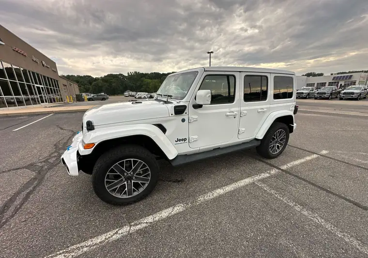 White 2024 Jeep Wrangler in a parking lot in Springfield, Michigan