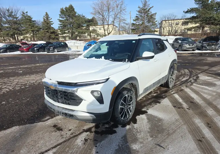 White 2024 Chevrolet Trailblazer covered in snow on a lot in Saint Paul, Minnesota