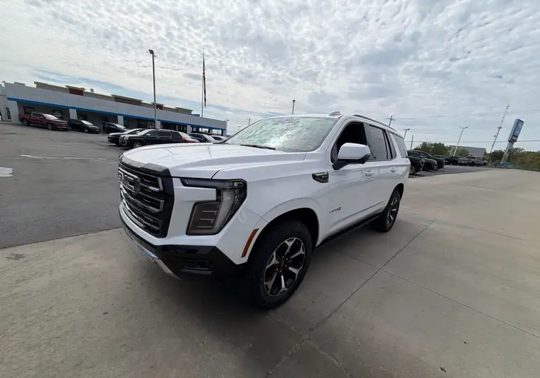 White 2025 GMC Yukon at a dealership lot at pickup in Liberty, Missouri