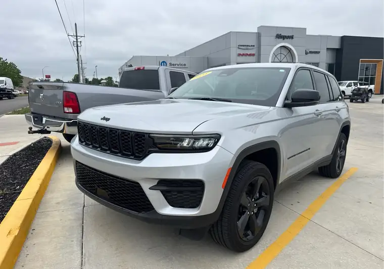 Silver 2025 Jeep Grand Cherokee at a dealership lot at pickup in Platte City, Missouri