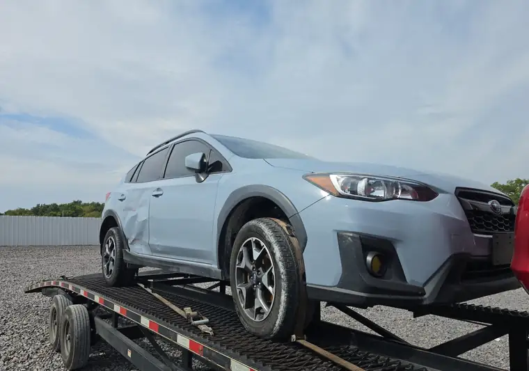Light blue 2019 Subaru Crosstrek on a car hauler at pickup in Columbia, Missouri