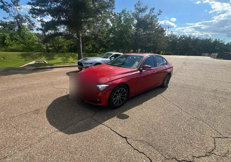 Red 2017 BMW 320i in a parking lot at pickup in Oxford, Mississippi