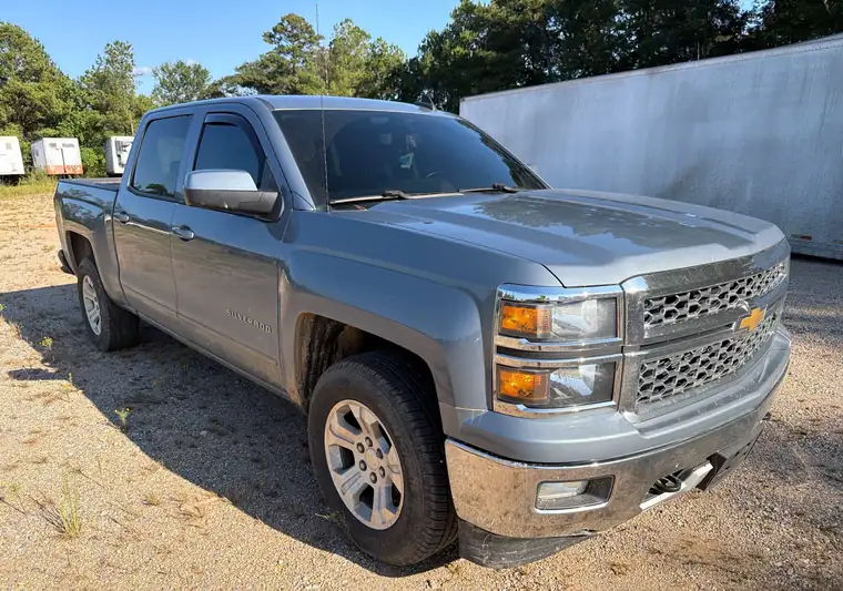 Gray Chevrolet Silverado 1500 crew cab on a gravel lot at pickup in Laurel, Mississippi
