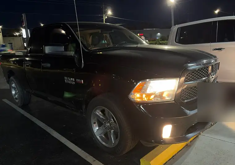 The same Ram 1500 in a parking lot at night at delivery in Fayetteville, North Carolina