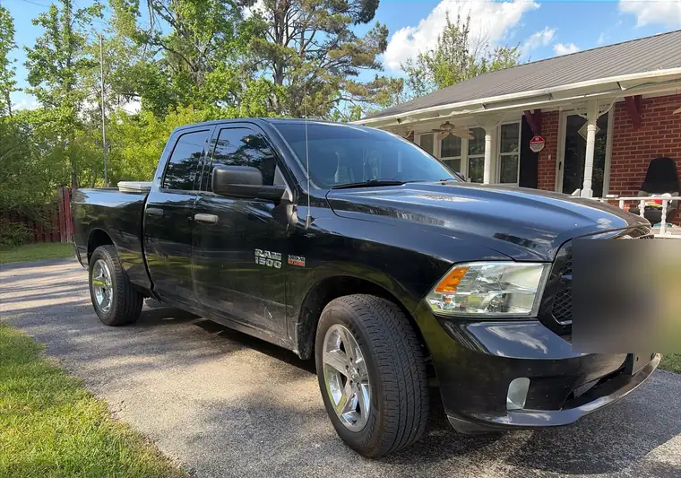 Black Ram 1500 pickup in a driveway at pickup in Booneville, Mississippi