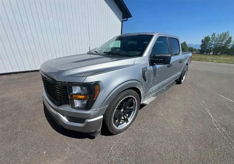 Silver lowered 2023 Ford F-150 crew cab in a parking lot at pickup in Kalispell, Montana