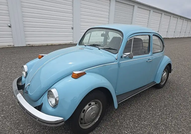 Light blue 1971 Volkswagen Beetle outside a storage unit row at pickup in Bozeman, Montana