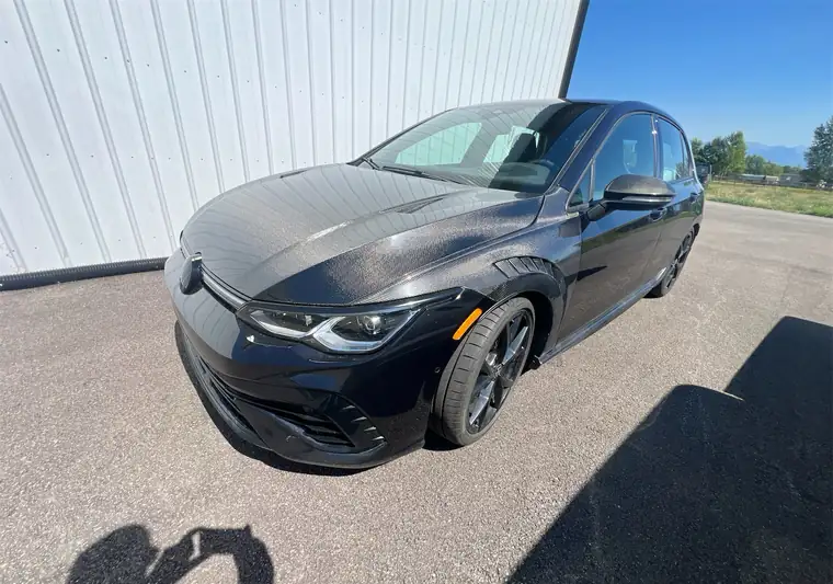 Black 2023 Volkswagen Golf R in a parking lot at pickup in Kalispell, Montana