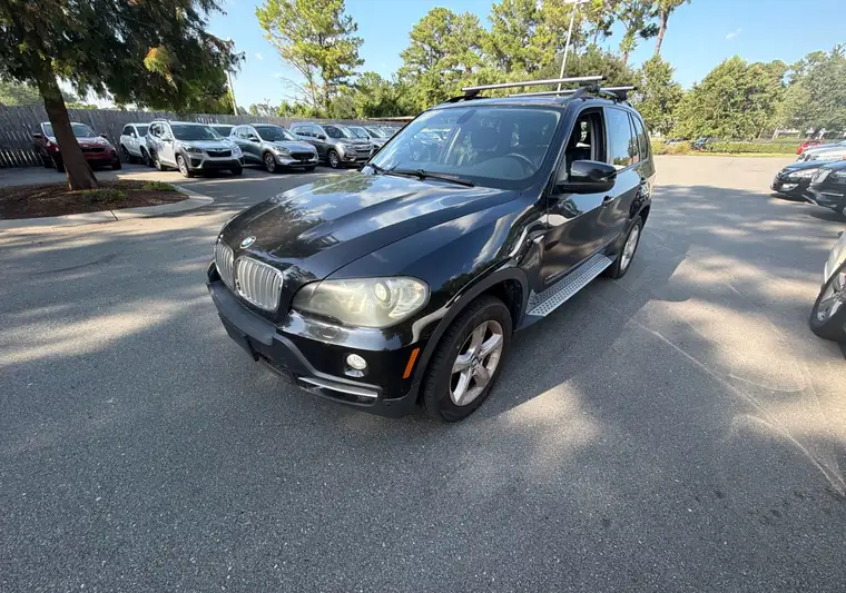 Black 2010 BMW X5 SUV in a parking lot at pickup in Wilmington, North Carolina