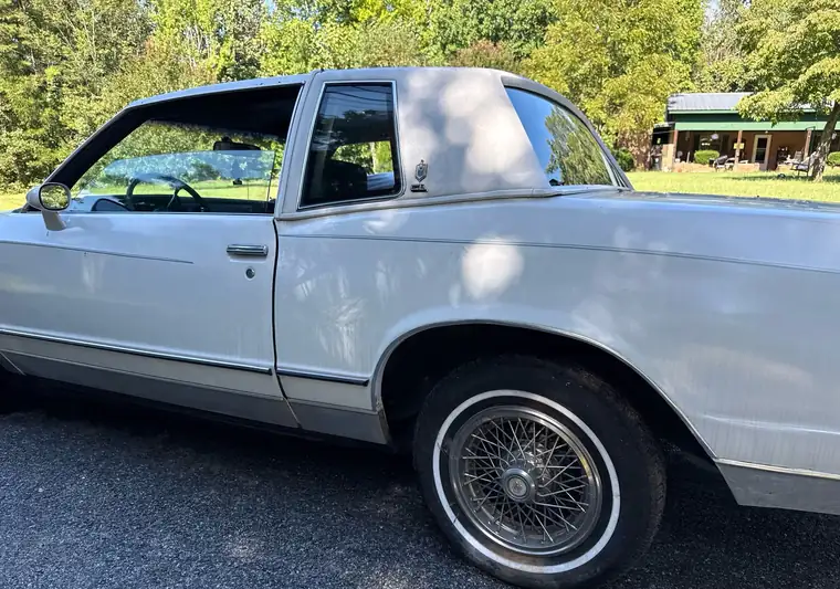 White 1985 Chevrolet Monte Carlo coupe with wire wheels in a driveway at pickup in Lexington, North Carolina