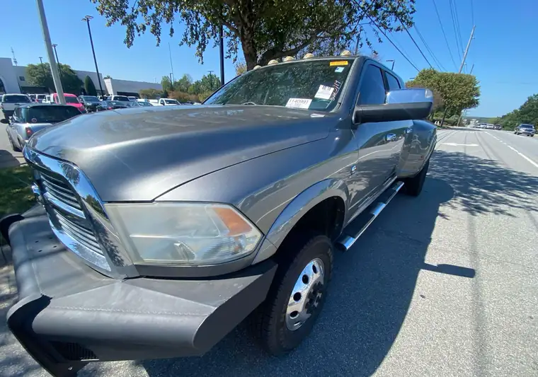 Gray 2012 Ram 3500 dually crew cab with a push bumper at the Manheim yard in Concord, North Carolina