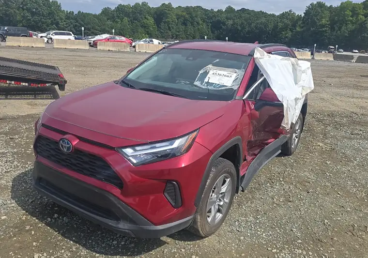 Red 2024 Toyota RAV4 Hybrid with collision damage on the right side at the IAA yard in Graham, North Carolina