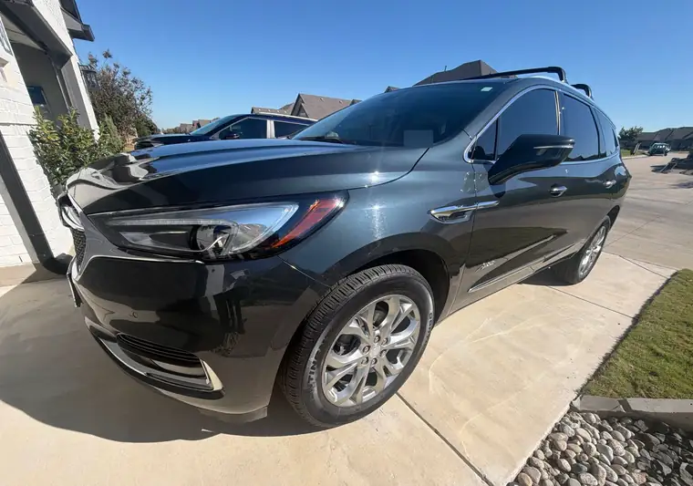 Dark gray 2021 Buick Enclave SUV parked in a driveway at pickup in Denton, Texas