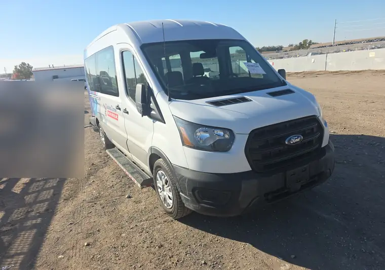 White 2020 Ford Transit passenger van on a dirt lot at pickup in Springfield, Nebraska
