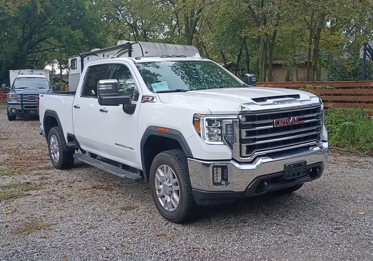 The same Sierra 2500HD on a gravel lot at delivery in Lawrence, Kansas