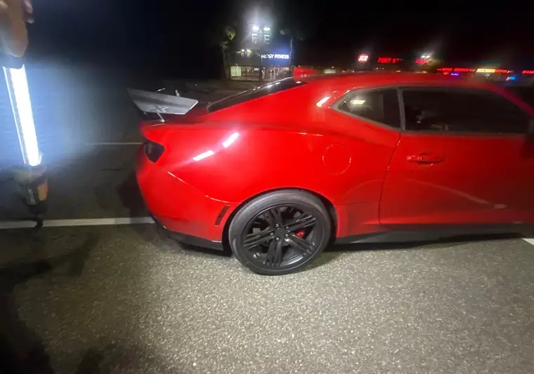 The same Camaro ZL1 at night in a parking lot at delivery in Northport, New York