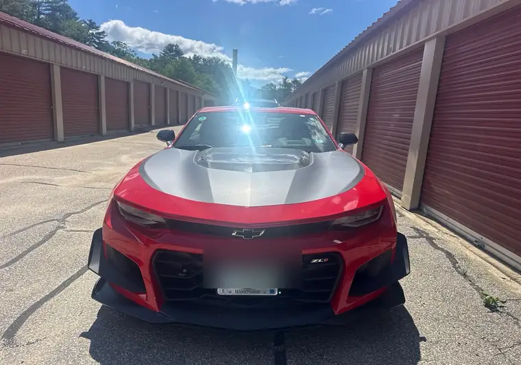 Red 2018 Chevrolet Camaro ZL1 with a silver hood at pickup in Plymouth, New Hampshire