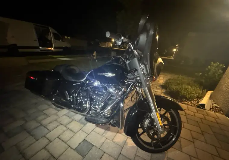 The same Street Glide at night on a paver driveway at delivery in Parrish, Florida