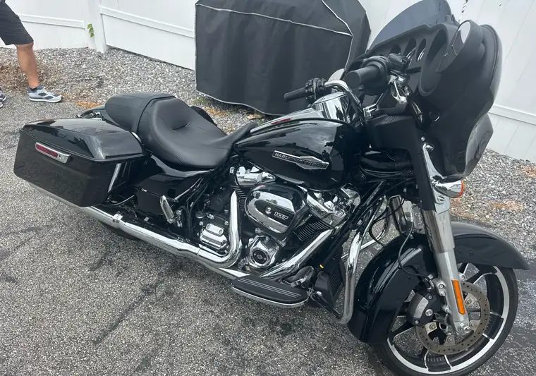 Black 2022 Harley-Davidson Street Glide motorcycle on a driveway at pickup in Manchester, New Hampshire