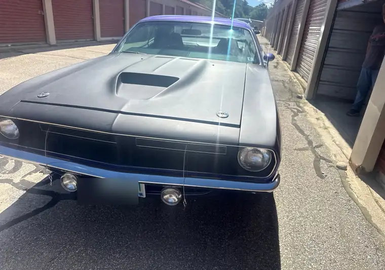 Purple and black 1970 Plymouth Cuda in front of a storage building at pickup in Plymouth, New Hampshire