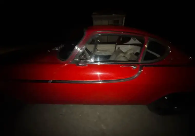 Red 1963 Volvo P1800 coupe photographed at night at pickup in Bradford, New Hampshire