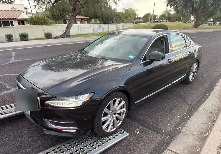 The same S90 on a car-hauler ramp at delivery in Phoenix, Arizona