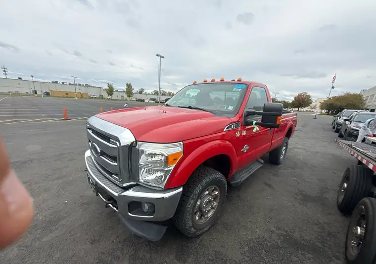 Red 2015 Ford F-350 Super Duty regular cab pickup in a parking lot at pickup in Manville, New Jersey