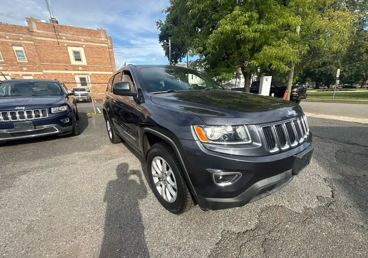 Dark gray 2015 Jeep Grand Cherokee in a dealer-style lot at pickup in Clifton, New Jersey