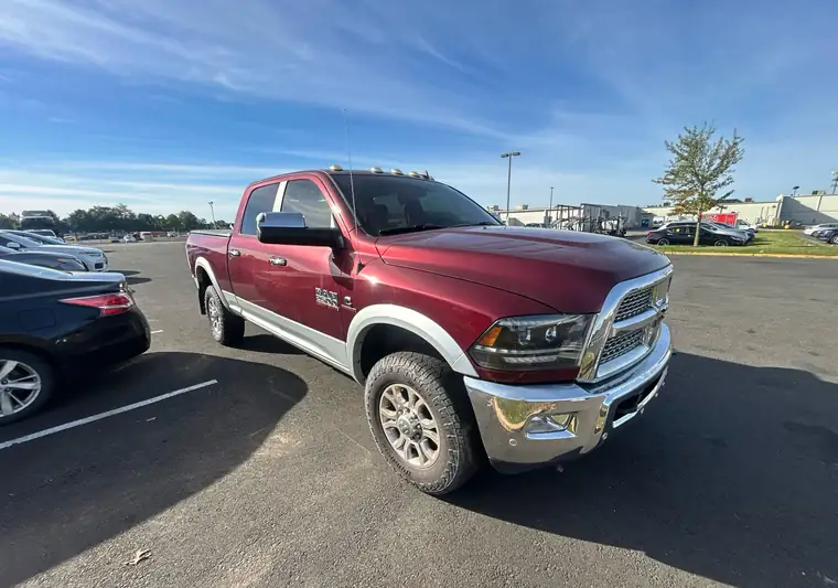 Maroon and silver 2018 Ram 2500 crew cab pickup in a parking lot at pickup in Manville, New Jersey