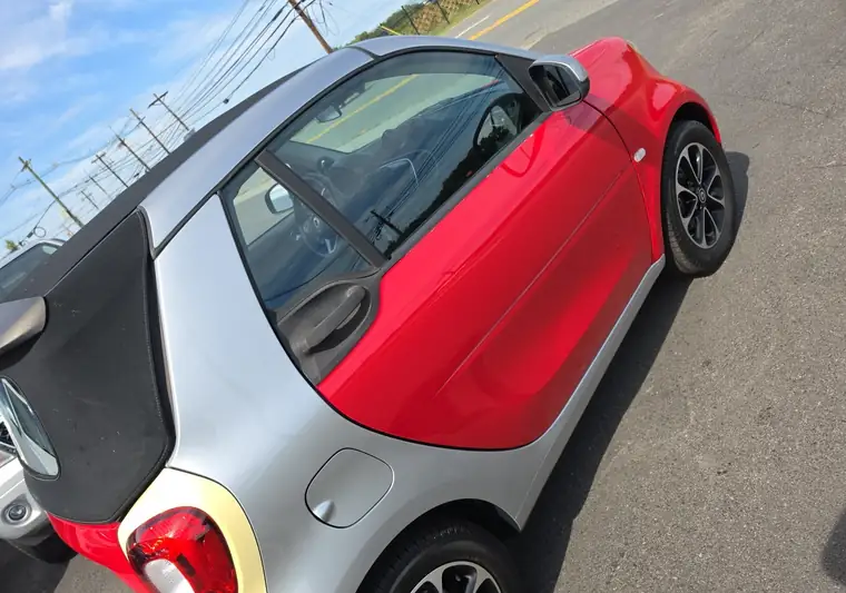 Red and silver Smart Fortwo cabriolet at pickup at a dealer in Moonachie, New Jersey