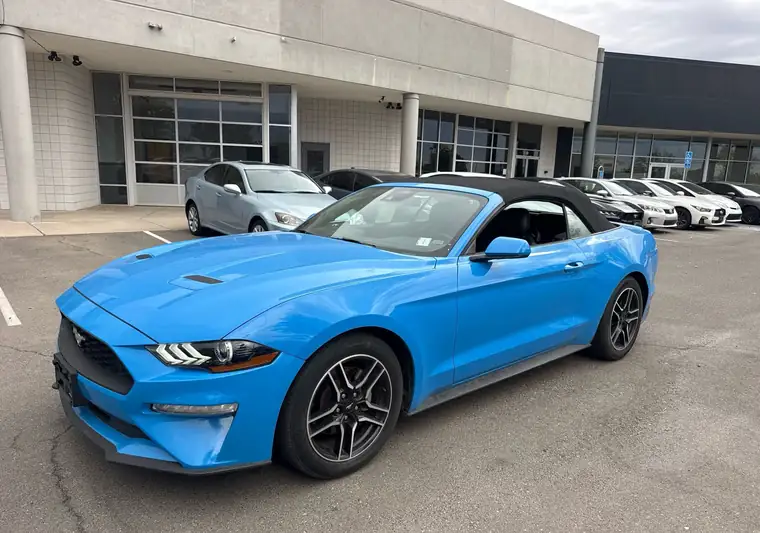 Blue 2023 Ford Mustang convertible at pickup at a dealer in Albuquerque, New Mexico