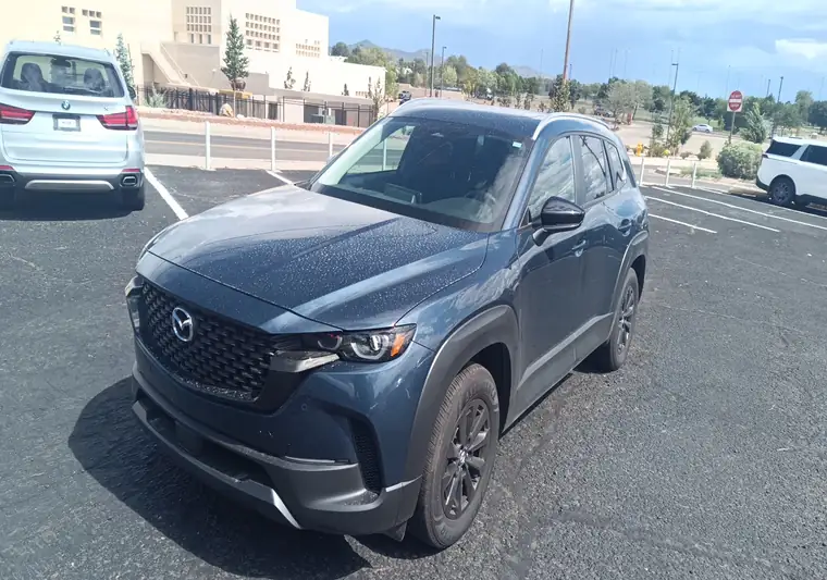 Dark blue 2026 Mazda CX-50 Hybrid SUV at pickup at a dealer in Santa Fe, New Mexico