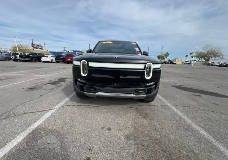 Black 2023 Rivian R1T electric pickup in a parking lot at pickup in Las Vegas, Nevada