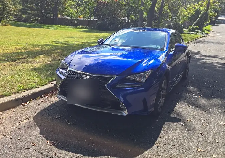 Blue 2015 Lexus RC 350 F Sport coupe parked on a street at pickup in Melville, New York (plate blurred)