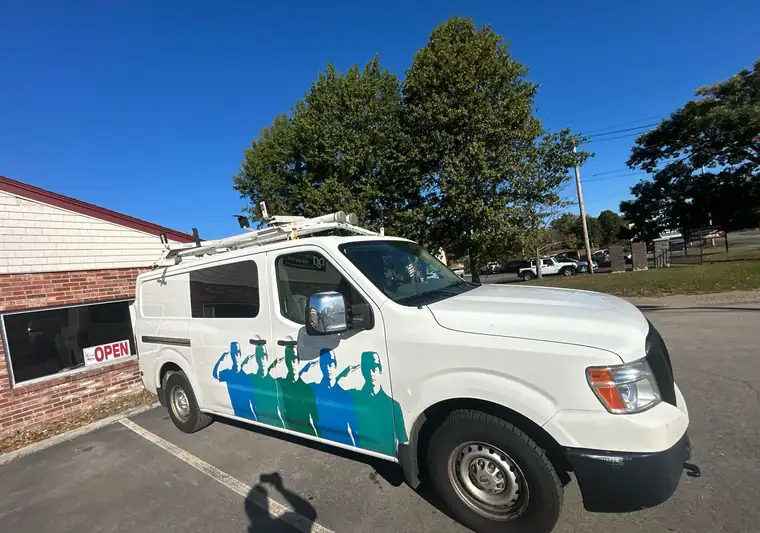 The same NV cargo van in a dealer lot at delivery in Rowley, Massachusetts
