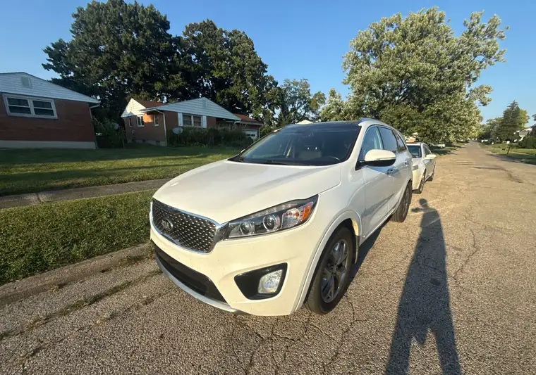 White 2016 Kia Sorento SUV parked on a residential street at pickup in Middletown, Ohio
