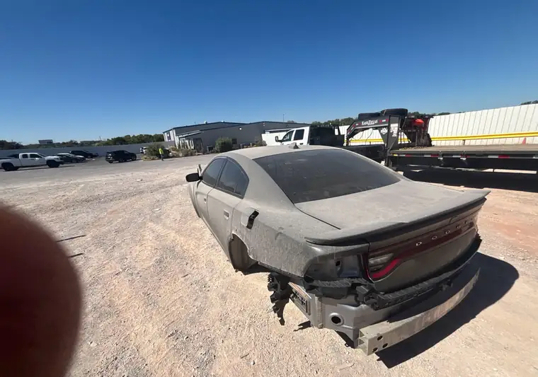 Wrecked gray 2015 Dodge Charger at the Copart yard in Oklahoma City