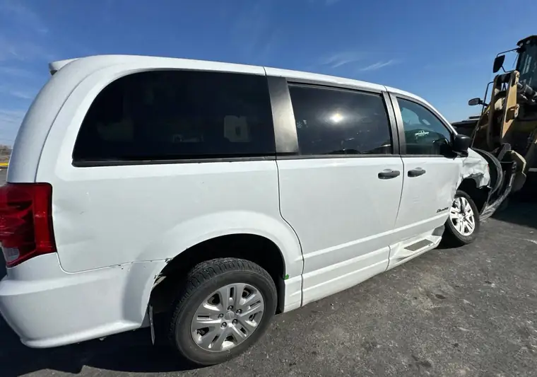 White 2019 Dodge Grand Caravan wheelchair-accessible van with front damage at the Copart yard in Tulsa, Oklahoma