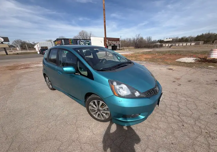 Teal 2012 Honda Fit hatchback on a road at pickup near Spencer, Oklahoma