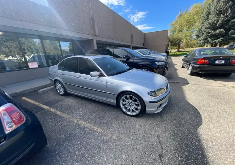 The same BMW 3 Series in a parking lot at delivery in Boulder, Colorado