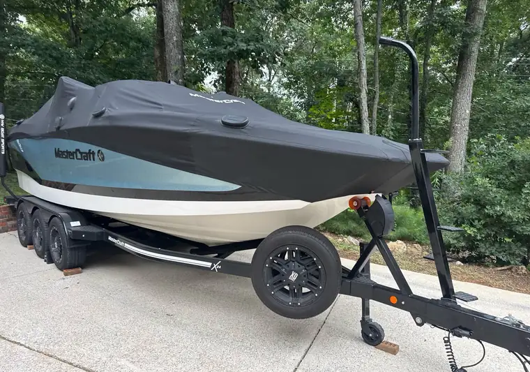 The same MasterCraft X23 on its trailer in a driveway at delivery in Huntsville, Alabama