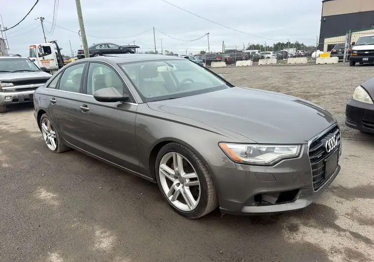 Gray 2015 Audi A6 sedan, front three-quarter view, at an auction lot at pickup in Philadelphia, Pennsylvania