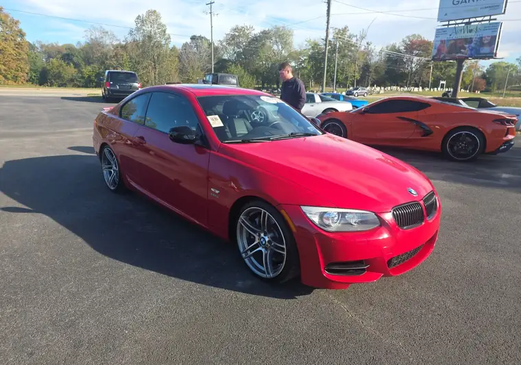 The same red BMW 335is coupe, front three-quarter view, at delivery in Kentucky