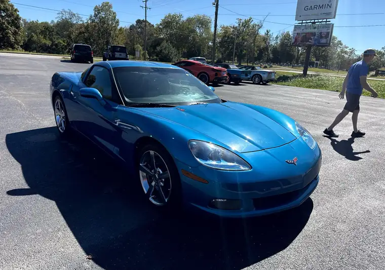 The same blue Corvette coupe in a dealer lot at delivery in Jamestown, Kentucky