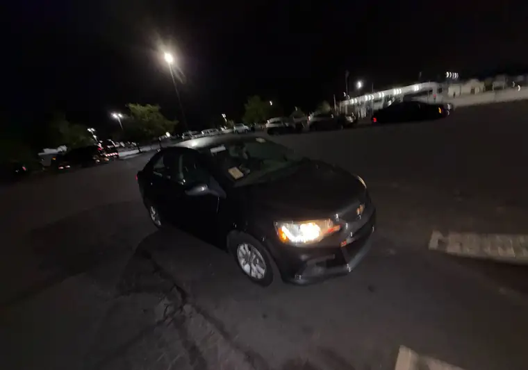Gray 2017 Chevrolet Sonic sedan at night at an auction lot at pickup in Hatfield, Pennsylvania