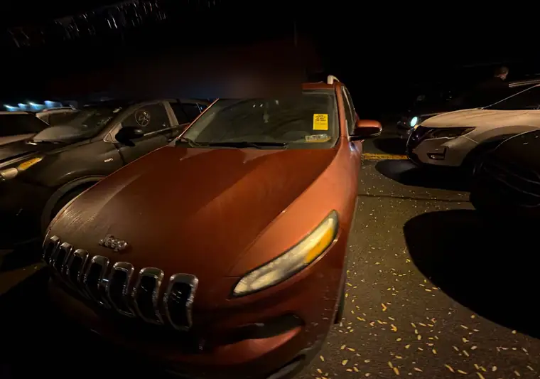 The same Jeep Cherokee in a dealer lot at night at delivery in Herkimer, New York